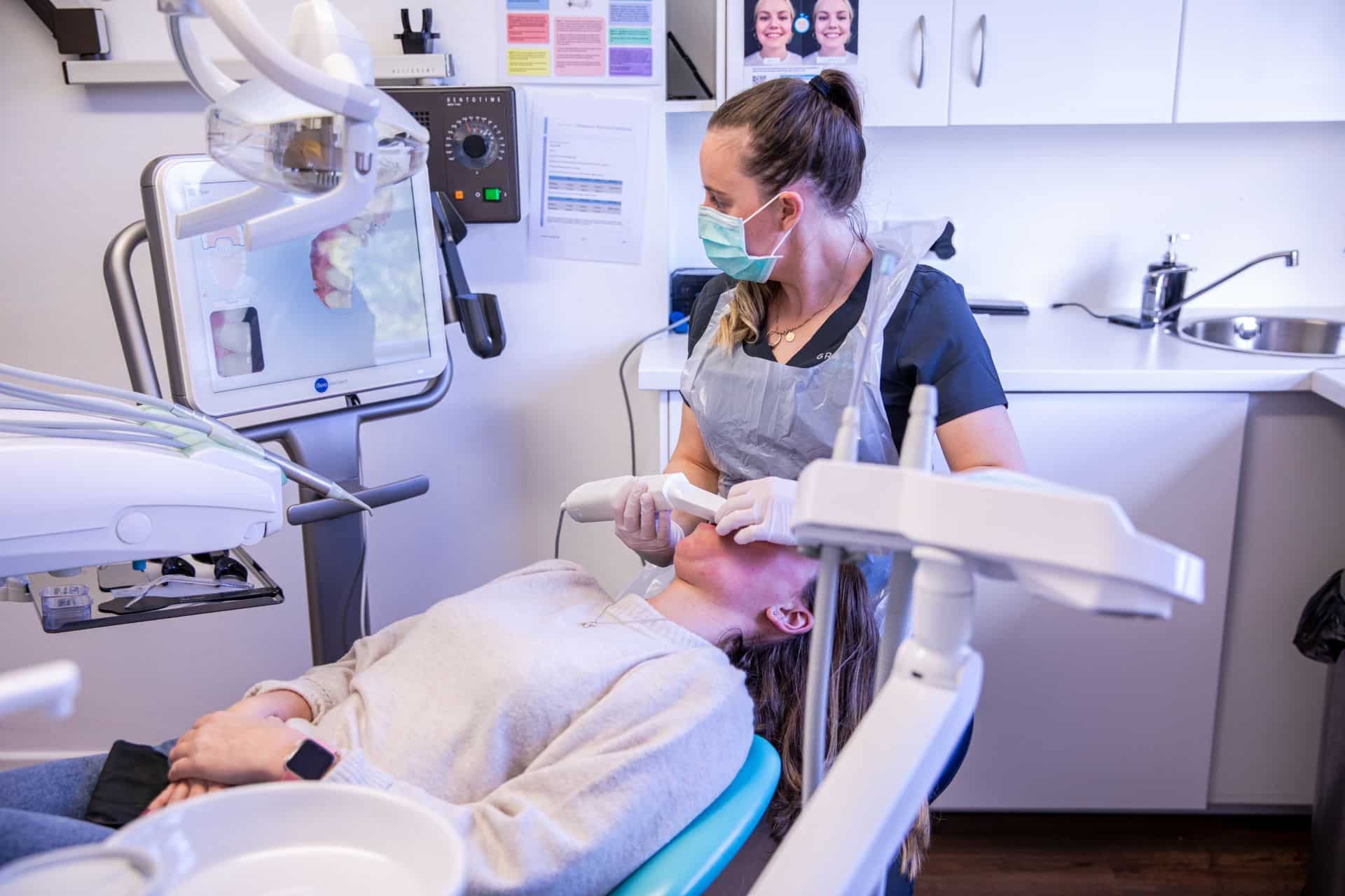 Dentist using iTero digital scanner on a patient
