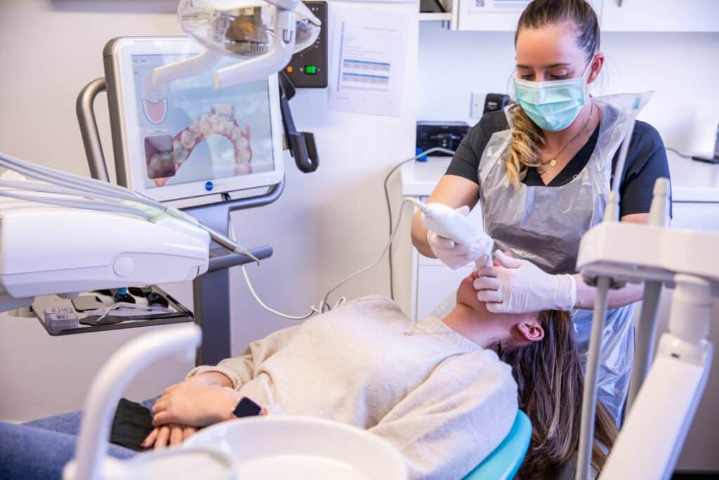 Dentist using iTero scanner during patient consultation