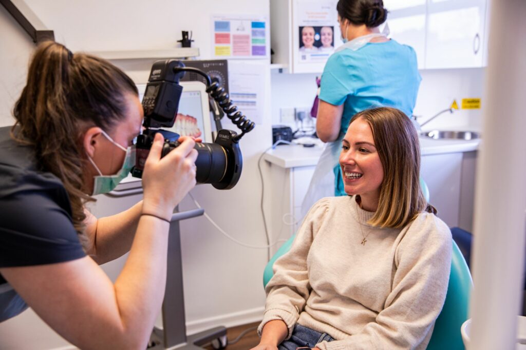 Photographer capturing patient smile results at Gransha Dental
